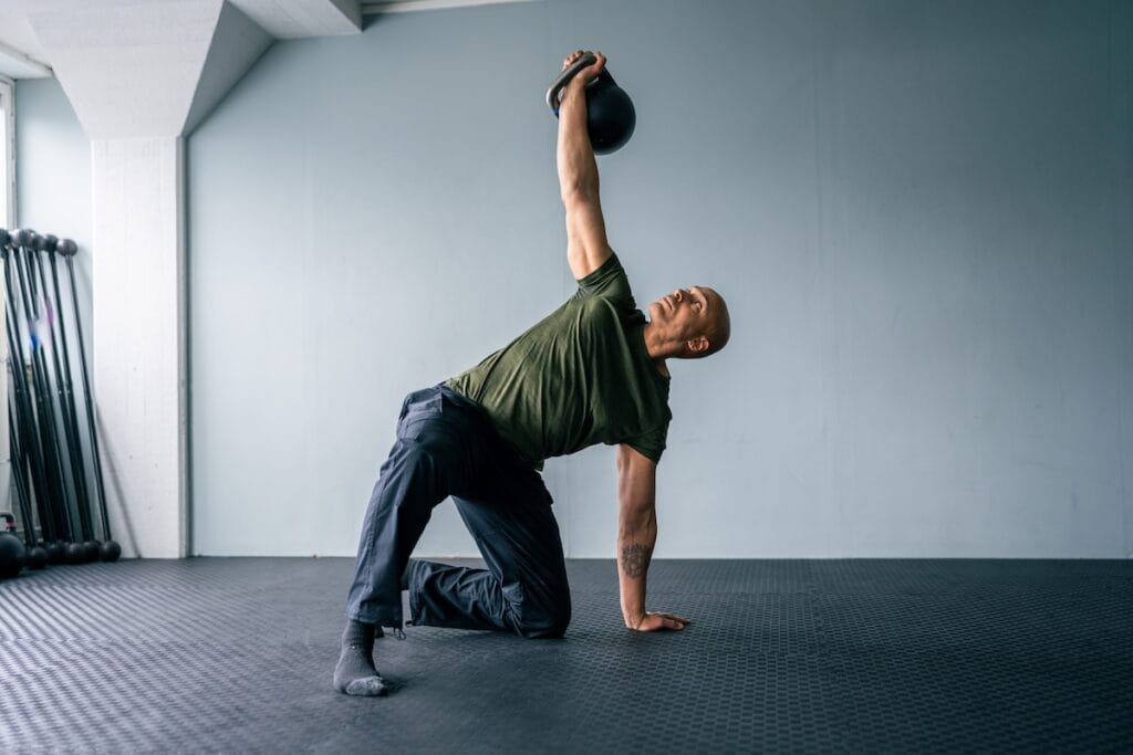 Coach Sami Obele demonstrating a kettlebell Turkish Get Up as part of an online strength and movement course.