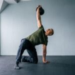 Coach Sami Obele demonstrating a kettlebell Turkish Get Up as part of an online strength and movement course.